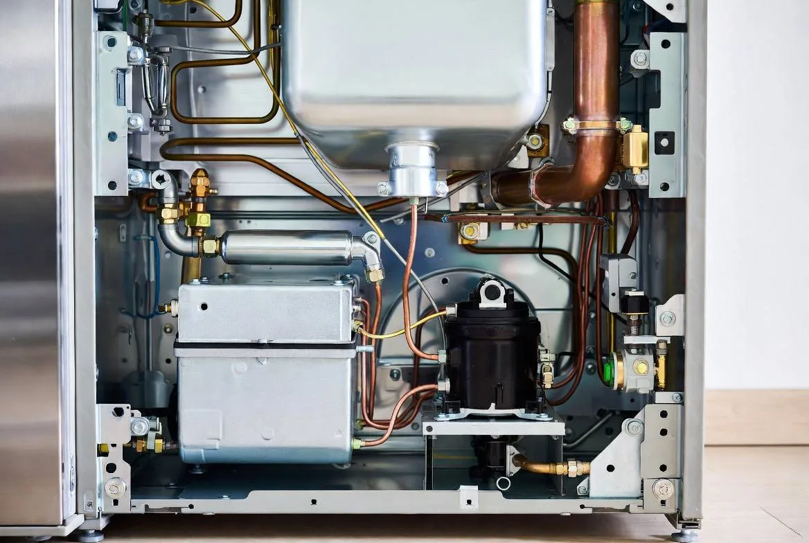 LG refrigerator compressor and coils exposed with rear panel removed